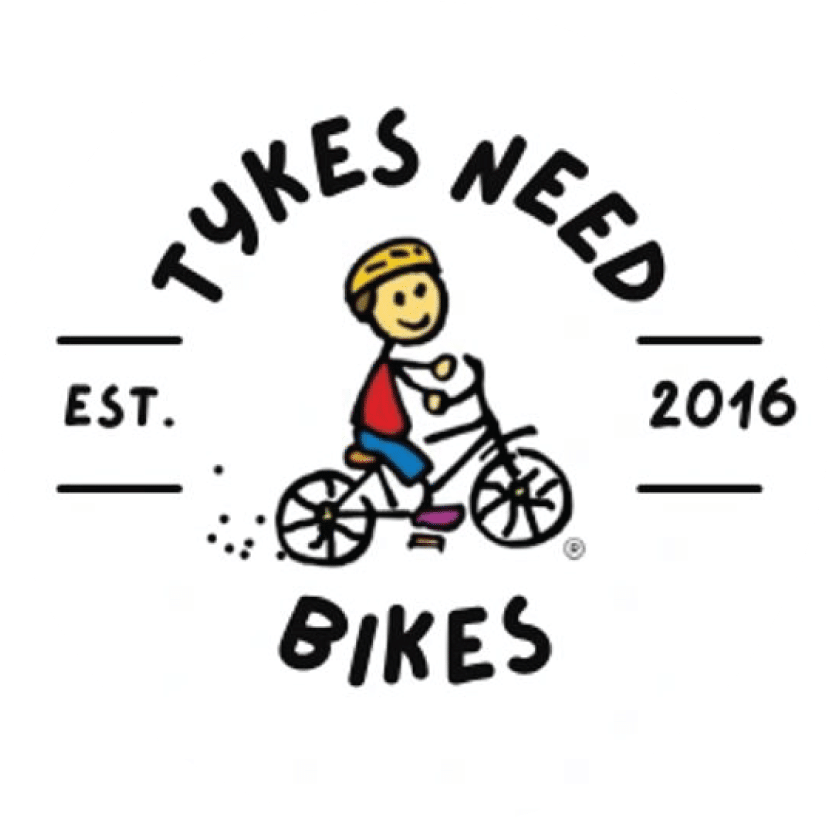 Logo for "Tykes Need Bikes" featuring a cartoon child riding a bicycle, with the text "Tykes Need Bikes" surrounding the image and "Est. 2016" on either side.