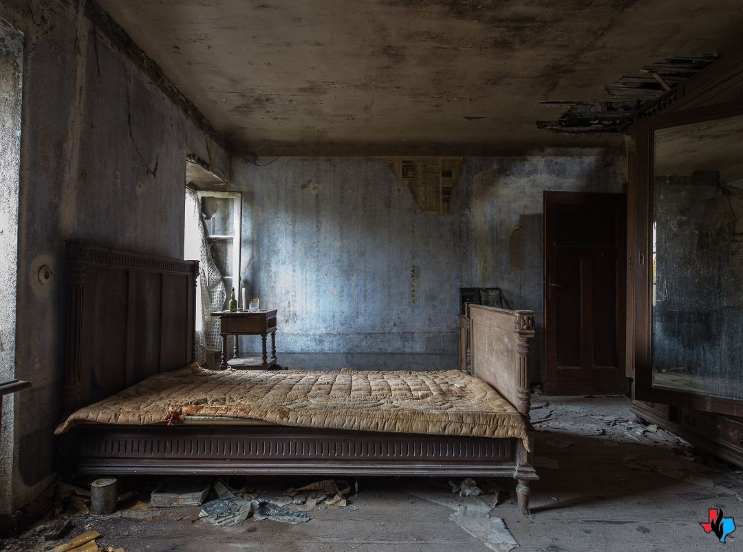 Emergency Fire Damage Experts in Cypress, TX – Burned and smoke-damaged bedroom with charred walls, soot-covered ceiling, and debris scattered across the floor. Precision Restoration offers 24/7 fire damage cleanup and repair services in Cypress, TX.