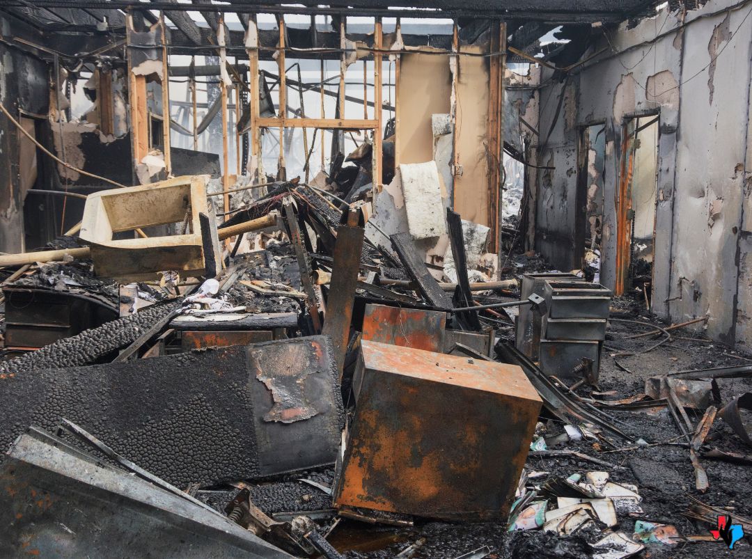 Severe fire damage to residential structure in Kingwood, TX with charred debris, collapsed furniture, and soot-covered walls—requiring 24/7 fire damage restoration by Precision Restoration.