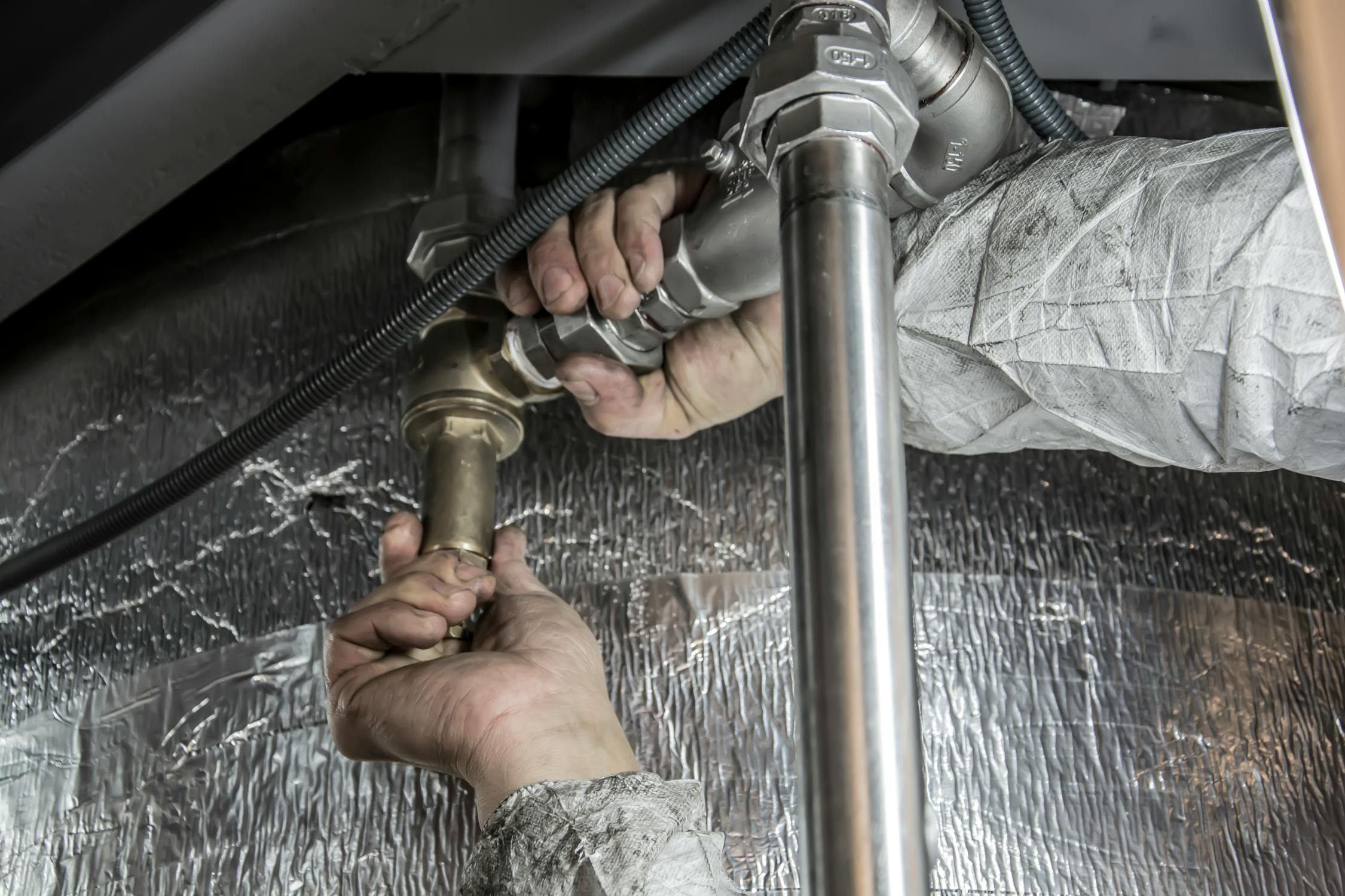 Professional plumber performing sewage backup cleanup in Spring TX